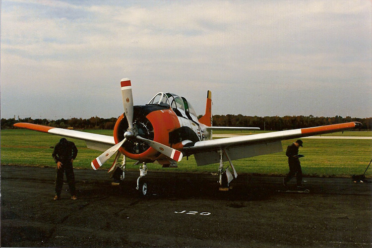 MicroProse T-28 before MicroProse paint job. I think this is around the time they were getting the plane and was around October 1987. I'm not sure who the people are.