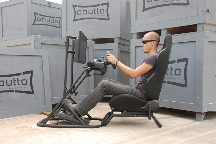 Chris Dunagan at the wheel of the Obutto oZone Gaming Cockpit setup in the sim racing configuration